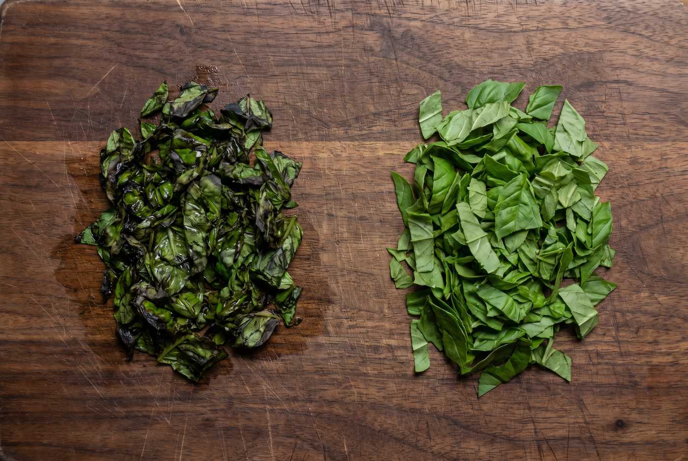 Bruised black basil beside basil cut with a sharp edge