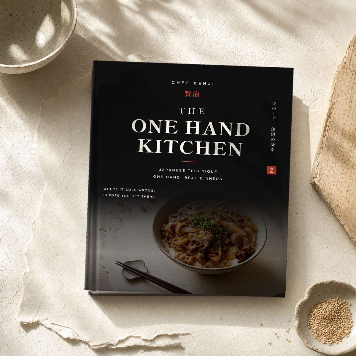 The One Hand Kitchen by Chef Kenji, a hardcover book on handmade paper in window light